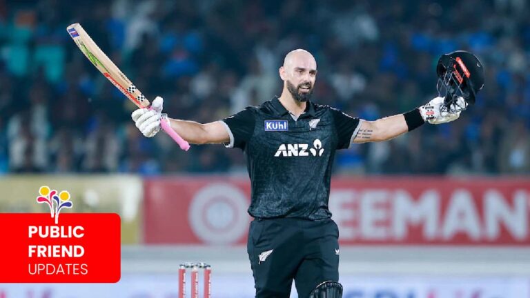 Daryl Mitchell raising his bat after the century